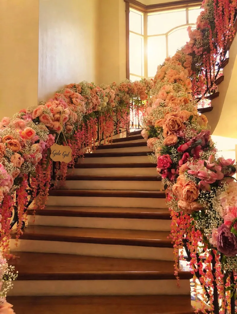 Peach Rose Staircase Decor: Peach and pink roses with baby's breath along both stair railings and hanging pink flower strings, GuleGul Flowers Lahore